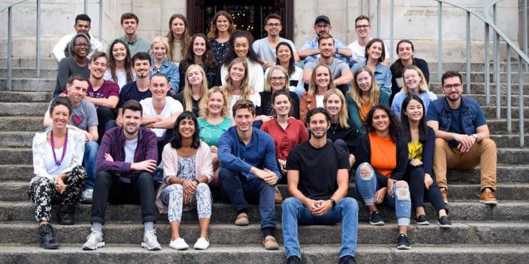 The MyTutor team sat together on some steps