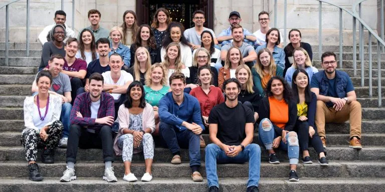 The MyTutor team sat together on some steps