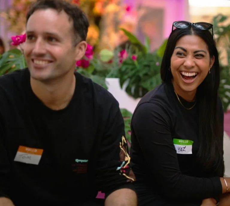 Two people sat side by side laughing