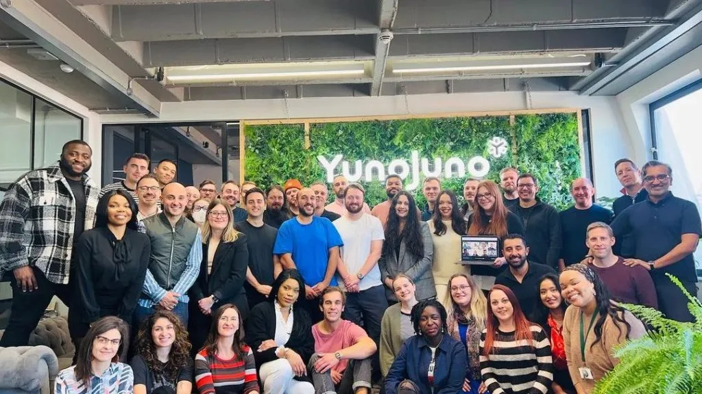 The YunoJuno team stood in their office